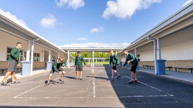 boys playing handball on a court 