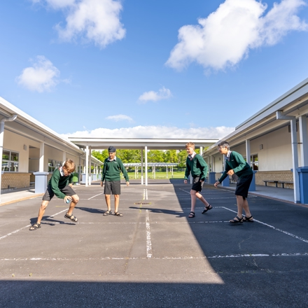 boys playing handball on a court 