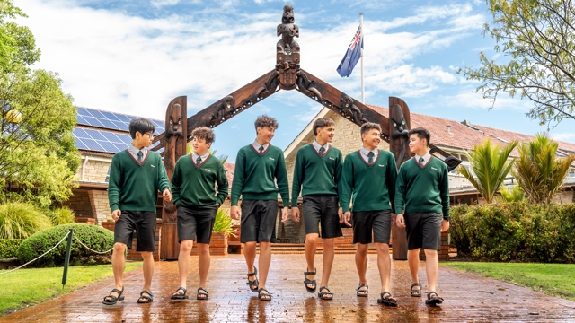 boys walking with the arch way in the background 