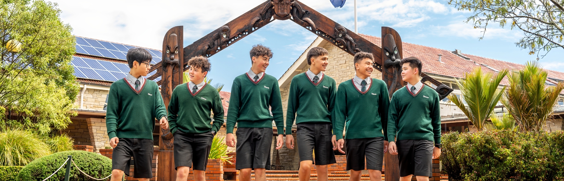 boys walking with the arch way in the background 