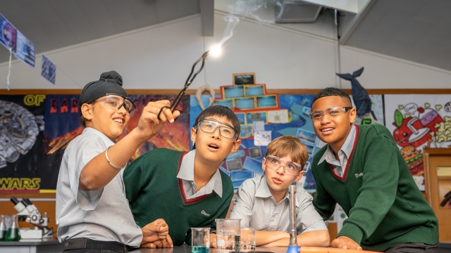 boys looking at a spark reaction in science class 