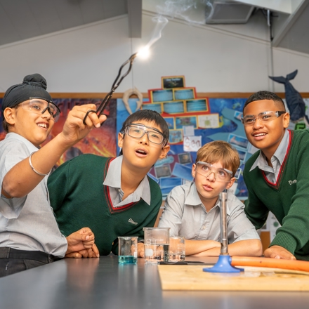 boys looking at a spark reaction in science class 