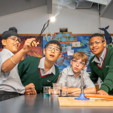 boys looking at a spark reaction in science class 