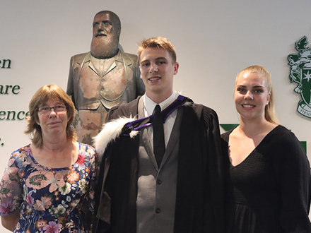 Dilworth Alumni standing in Senior Campus foyer with his family