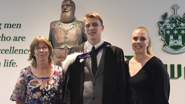 Dilworth Alumni standing in Senior Campus foyer with his family