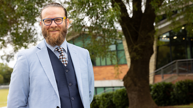 Director of Flourishing standing outside the Senior Campus gymnasium