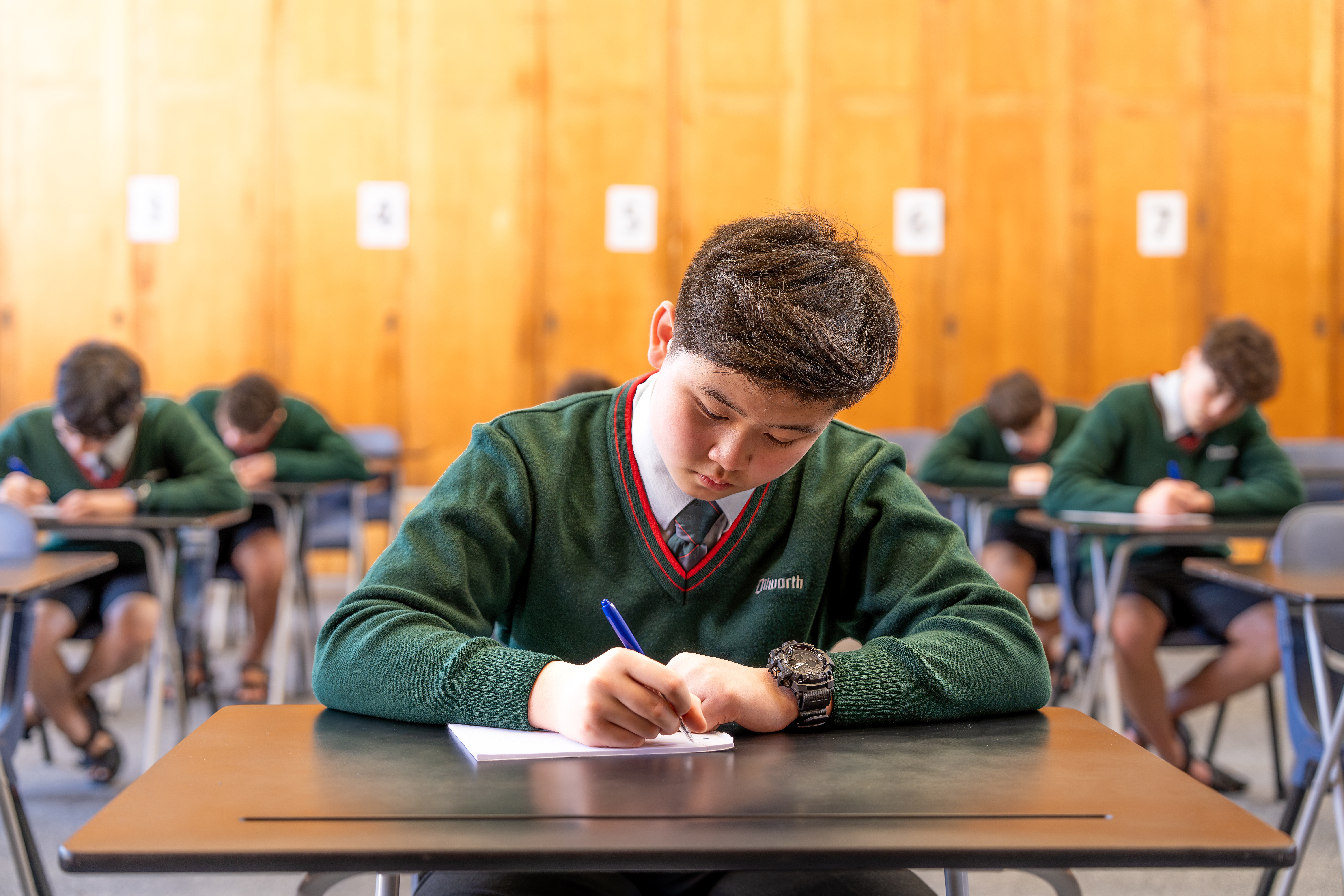 student sitting at a desk doing an exam