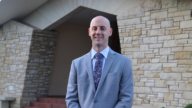 Director of Boarding standing in front of the Senior Campus