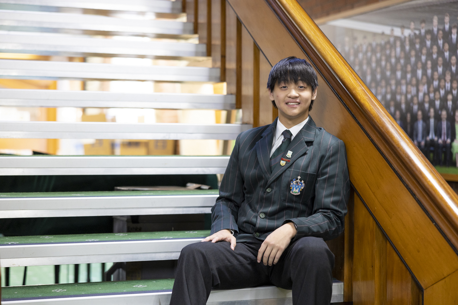 Dilworth Head Prefect sitting on stairs in the Dilworth Senior Campus foyer