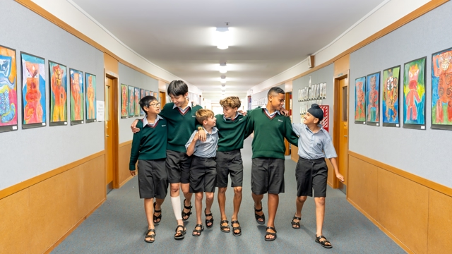 boys walking down a school hallway