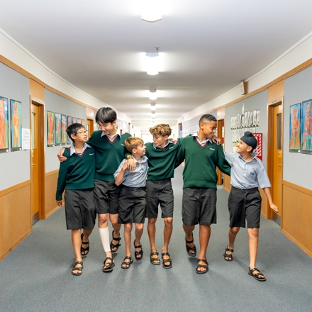 boys walking down a school hallway