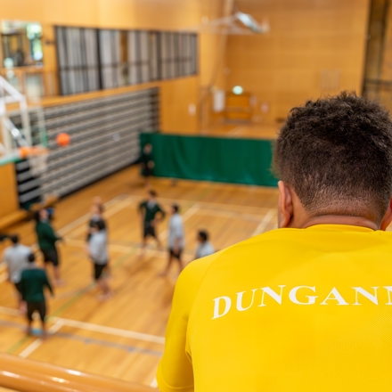 Dungannon house student watching other students play basketball