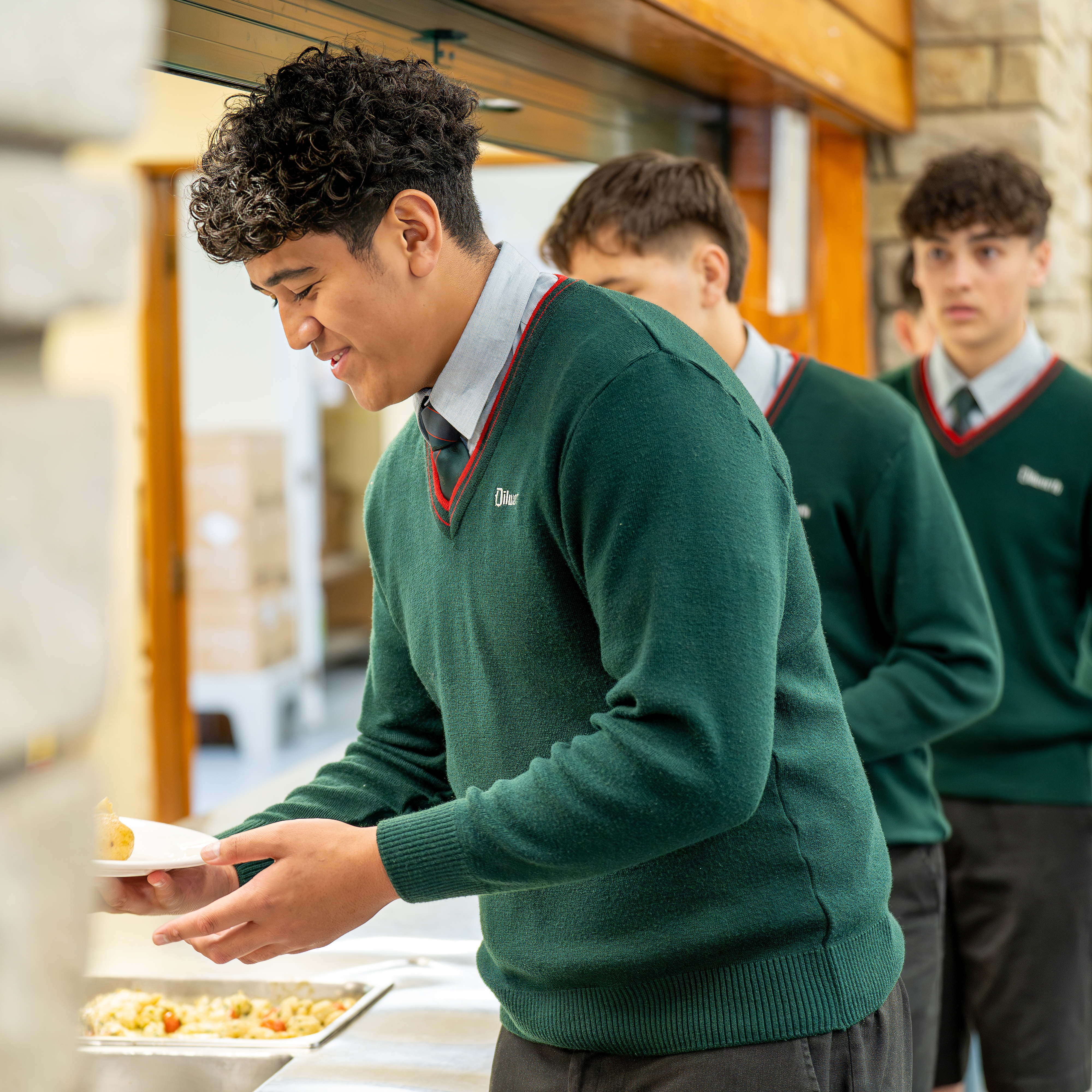 students being served lunch in the dining hall