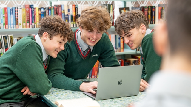 students looking at laptop screen