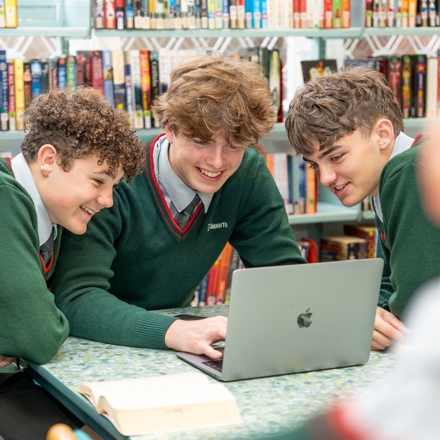 students looking at laptop screen