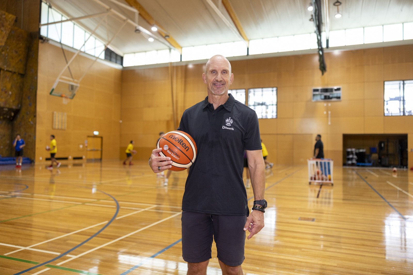 Head of coach and athlete development on the basketball court holding basketball