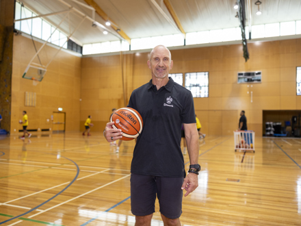 Head of coach and athlete development on the basketball court holding basketball