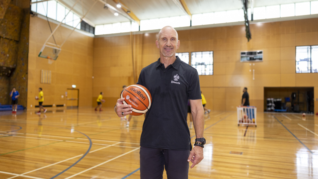 Head of coach and athlete development on the basketball court holding basketball