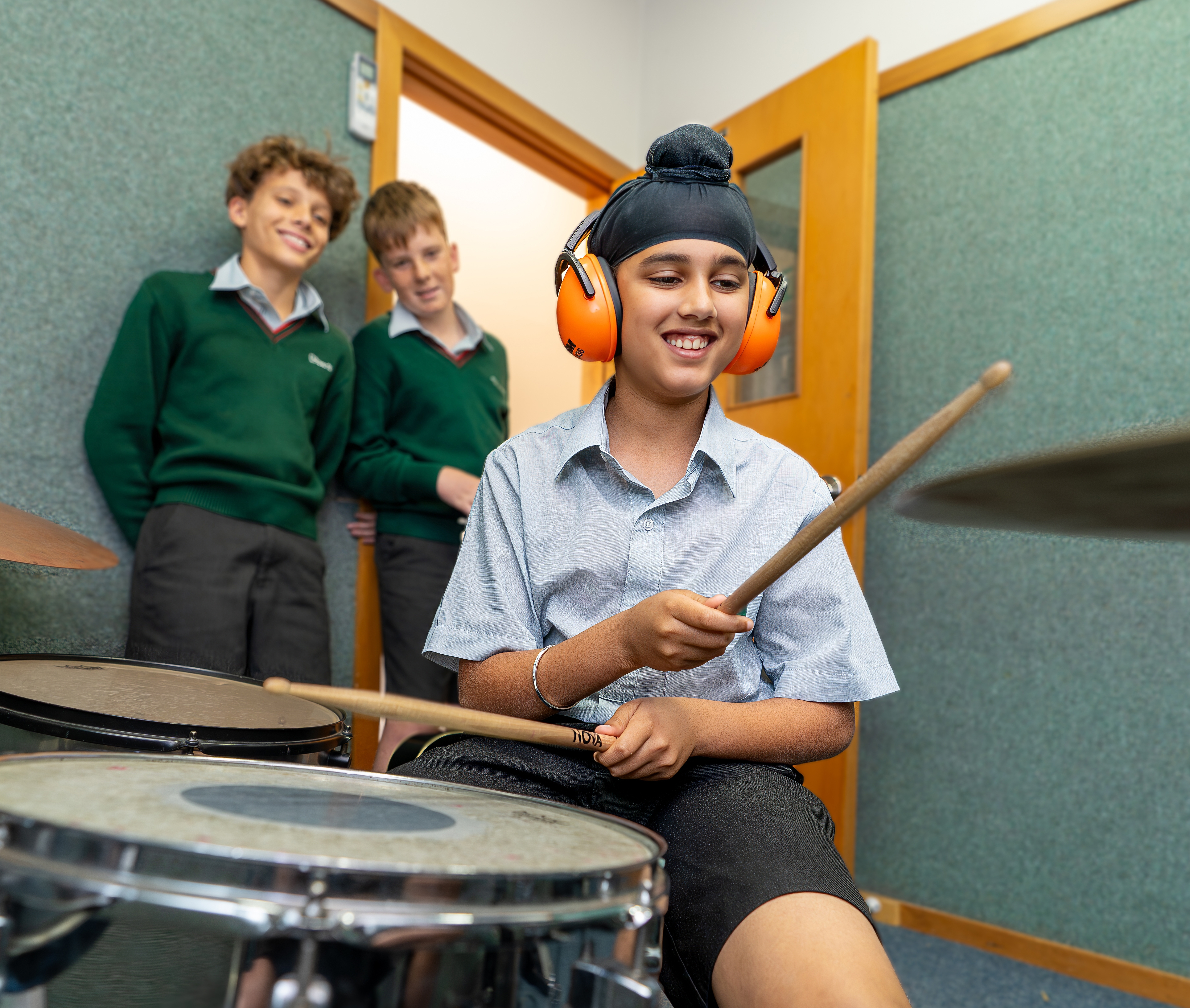 boy playing the drums in music class