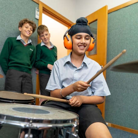 boy playing the drums in music class