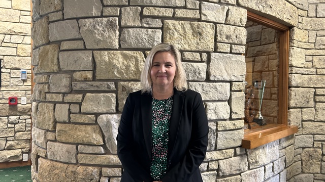 Director of Curriculum standing in the Dilworth Senior Campus Foyer