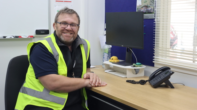 Director of Health and Safety sitting at his desk 