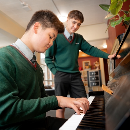 student playing piano in the boarding house 