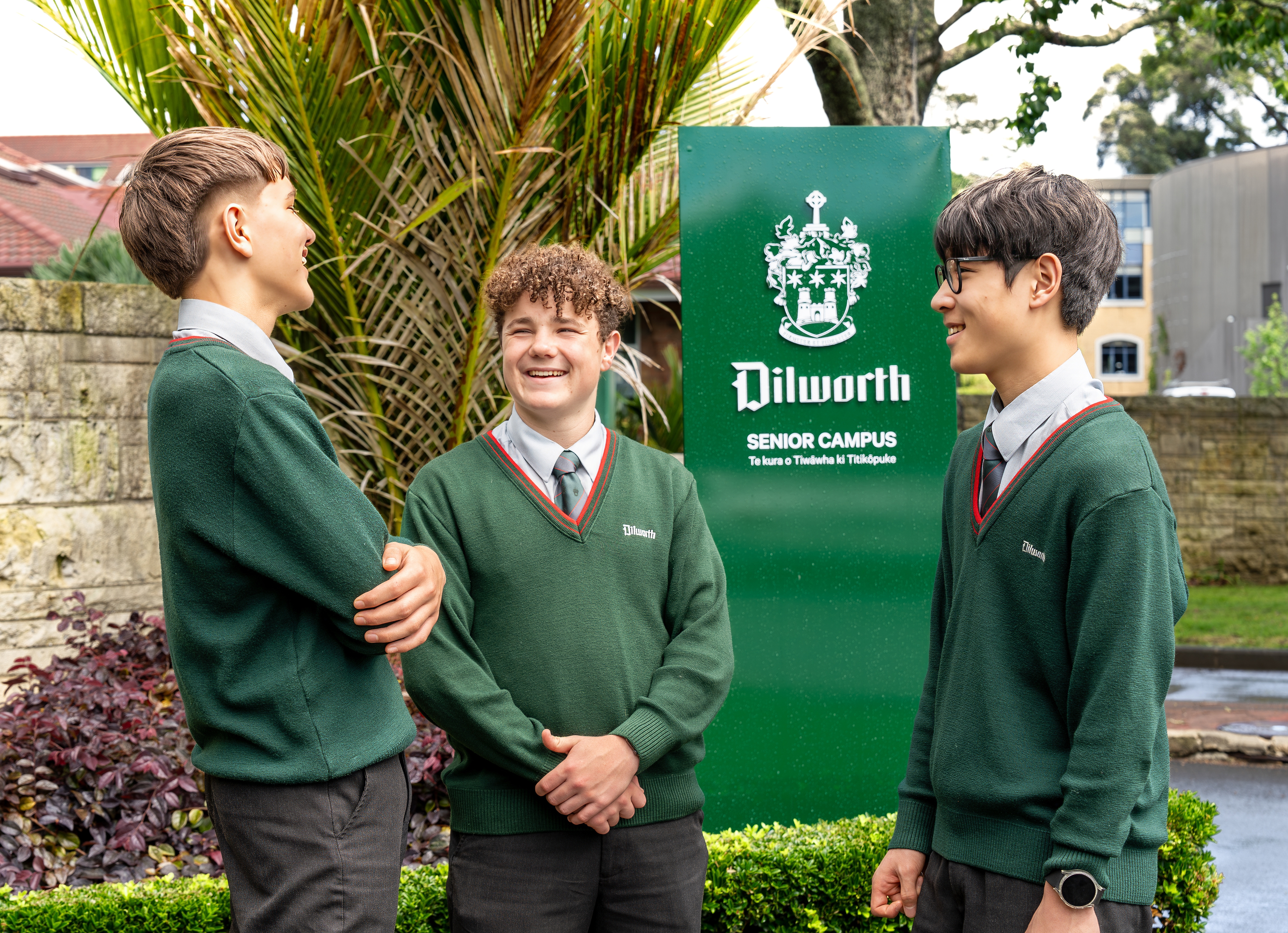 boys standing and talking by the Dilworth sign